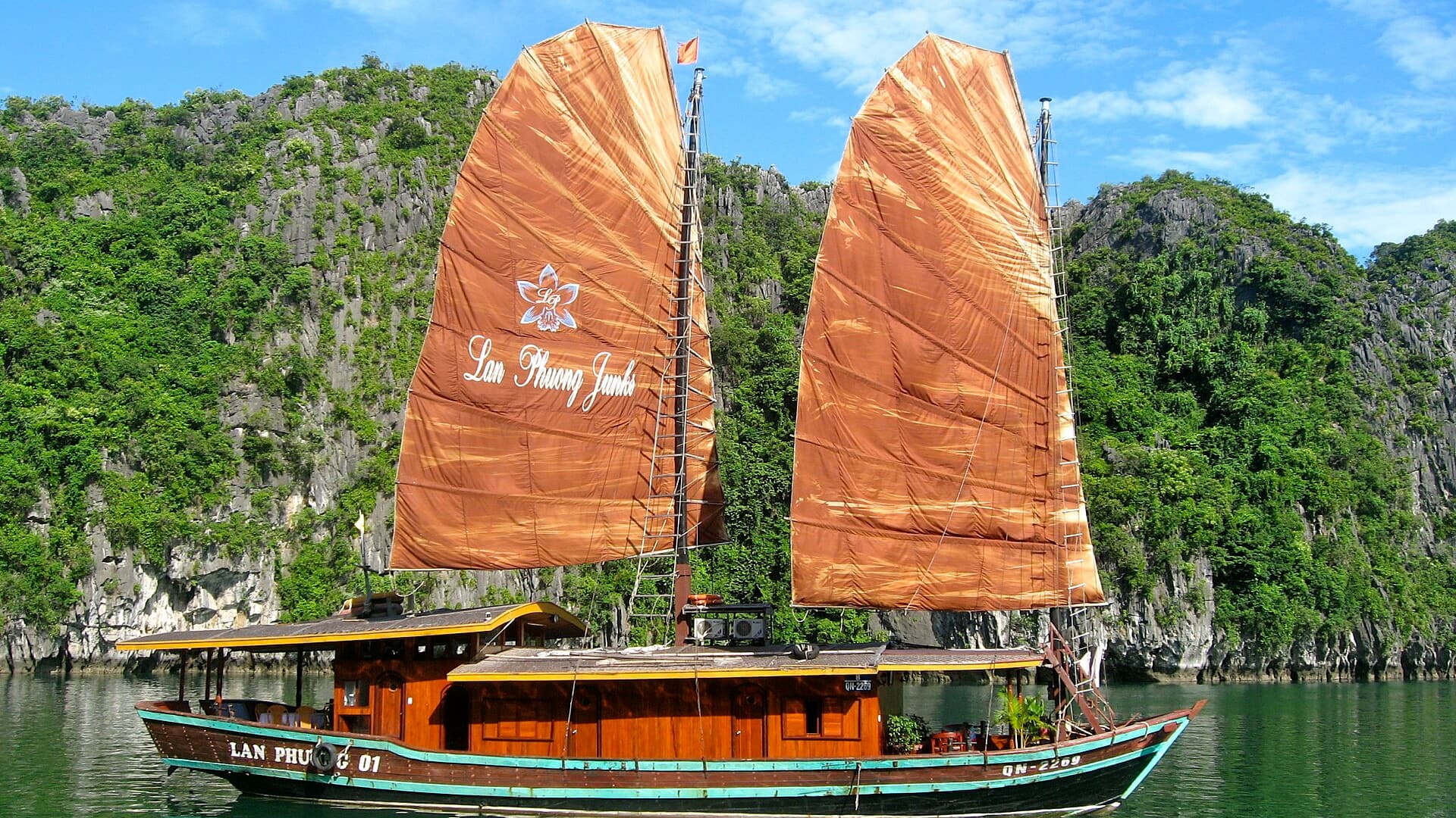 A traditional junk boat among the limestone karsts of Ha Long Bay